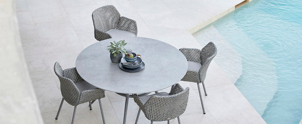 Edgy and raw outdoor dining area with exclusive dining table and cosy outdoor chair 