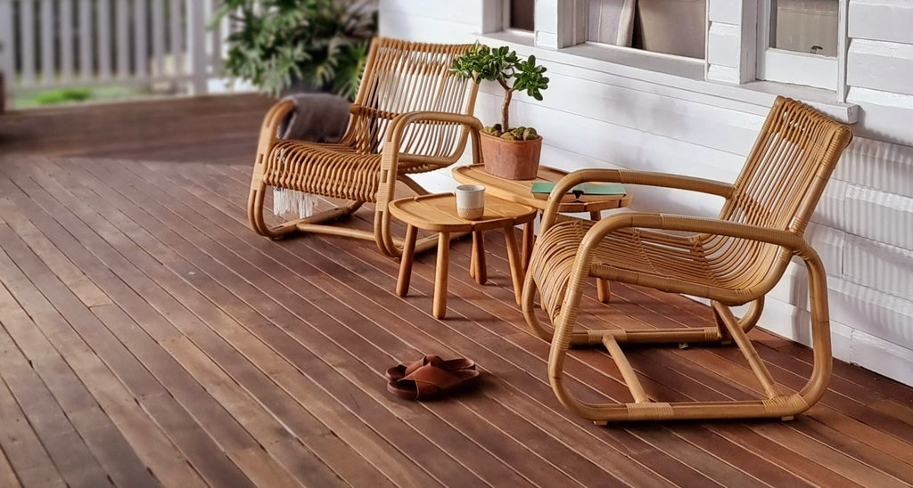 Two lounge chair in natural colour with teak side tables on veranda 