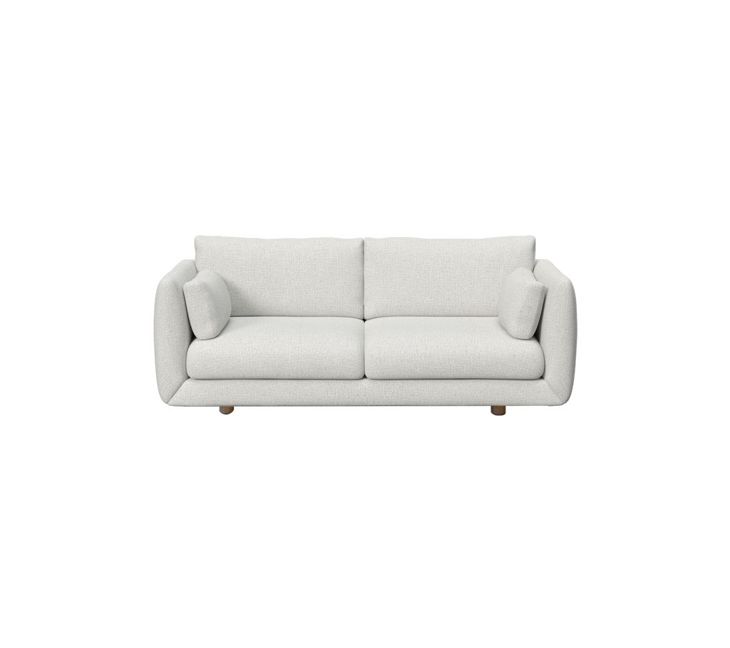 Canapé gris clair avec des coussins ronds dans un style moderne et minimaliste.