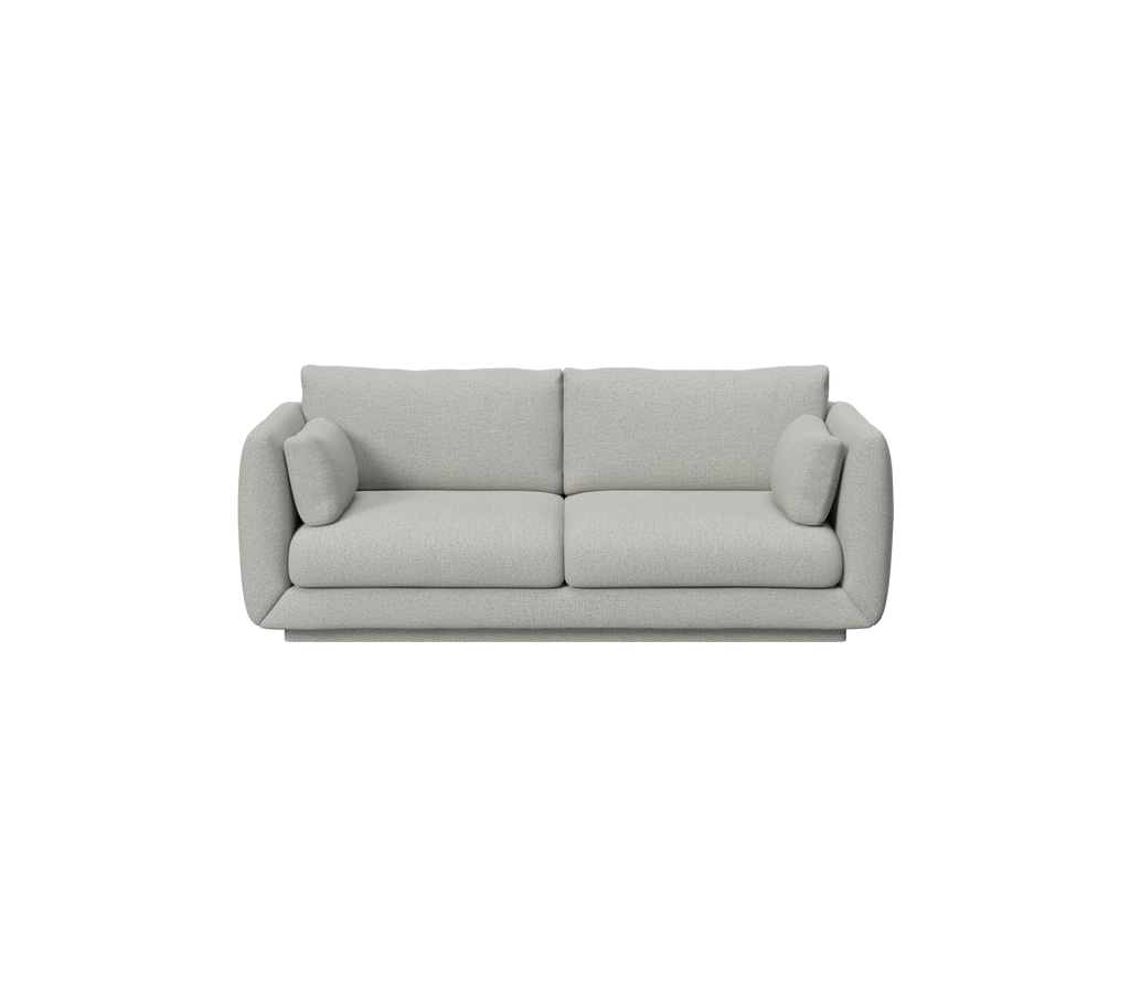 Canapé gris clair au design minimaliste et coussins ronds.