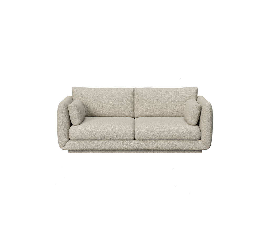 Canapé marron clair avec des coussins ronds dans un design moderne.