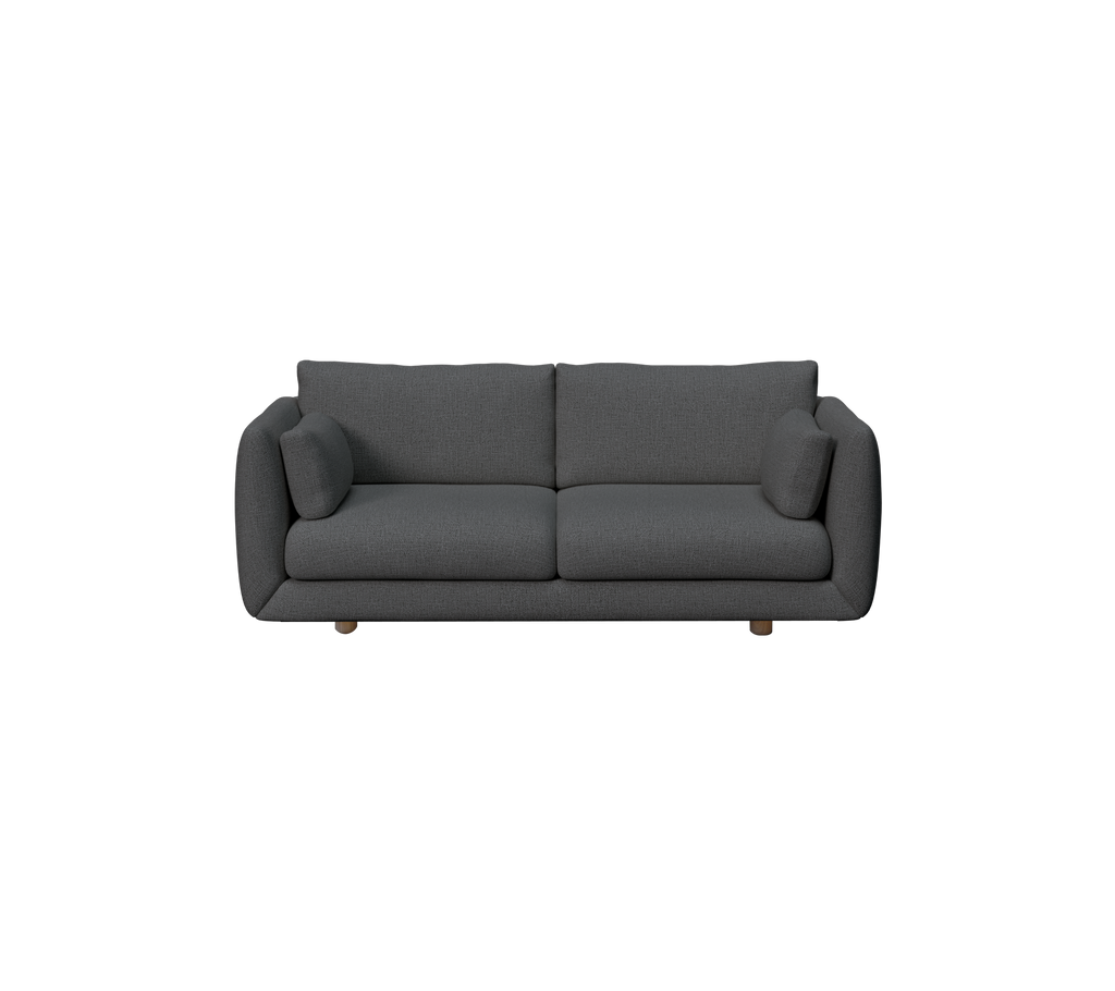 Sofa verte foncé avec deux coussins dans un cadre de salon moderne.