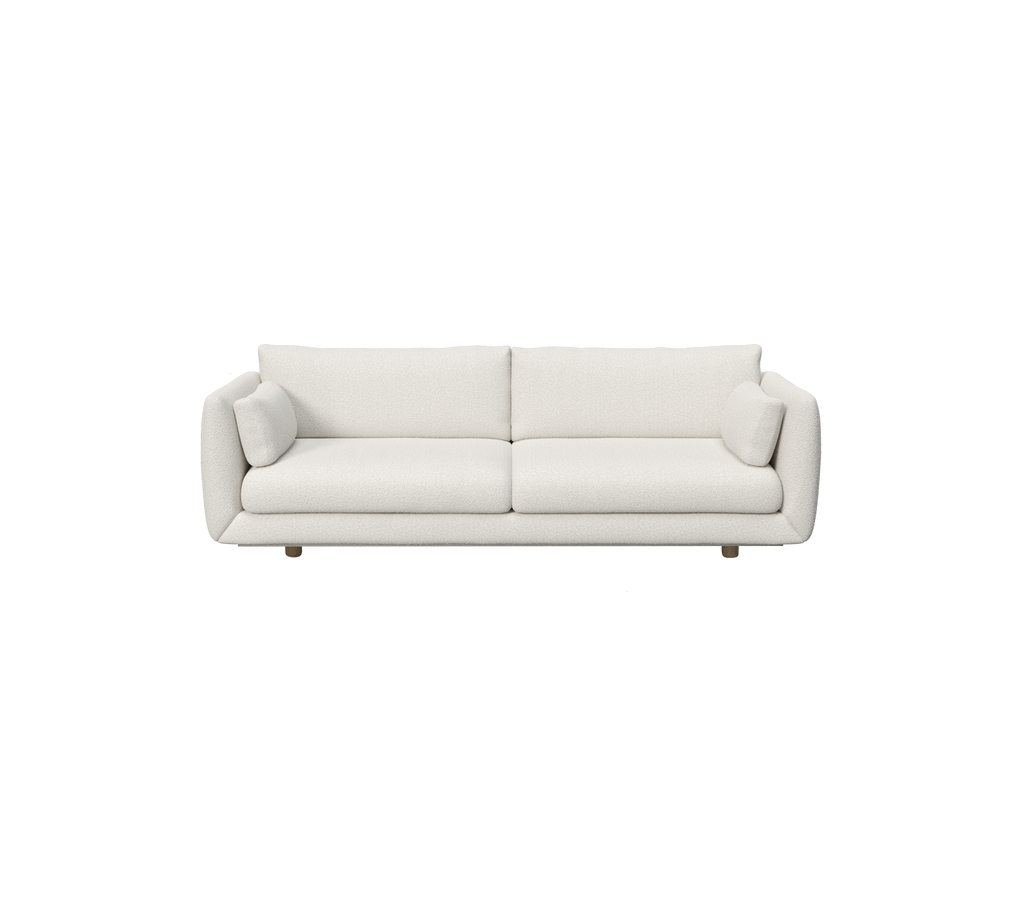 Canapé blanc moderne avec des coussins cylindriques.