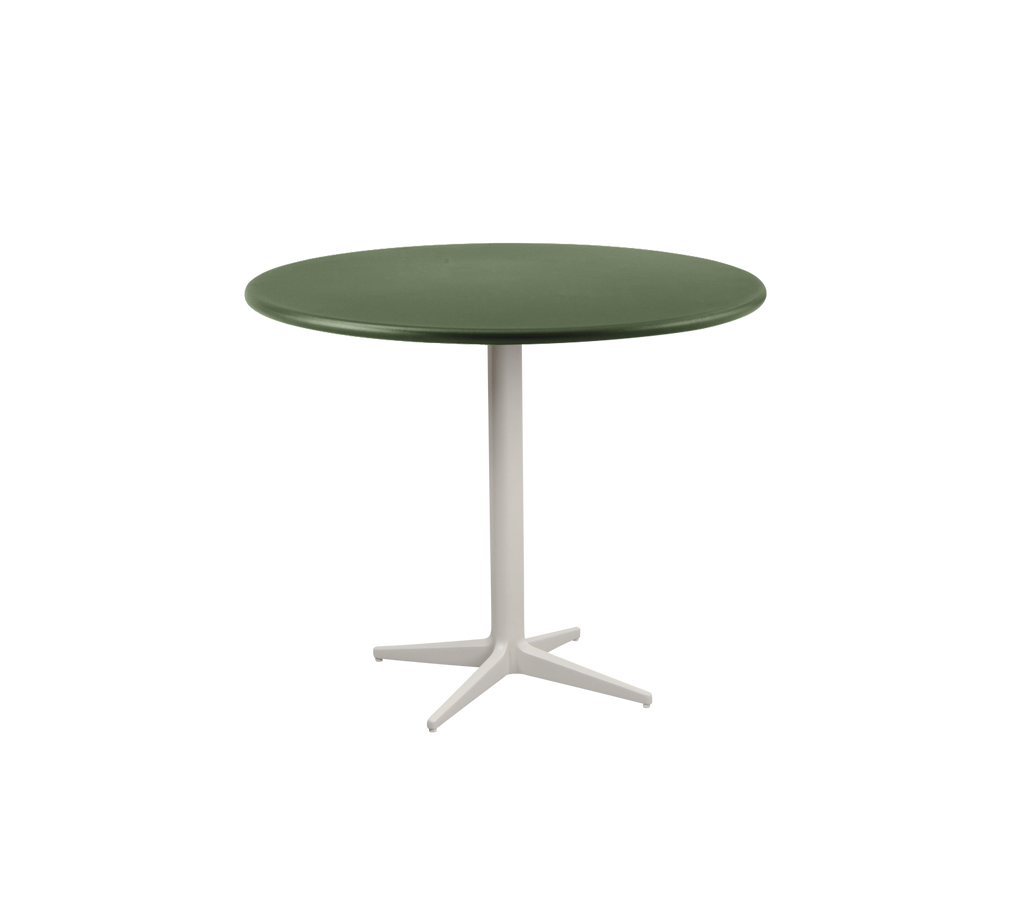 Table ronde verte foncée avec un pied blanc.