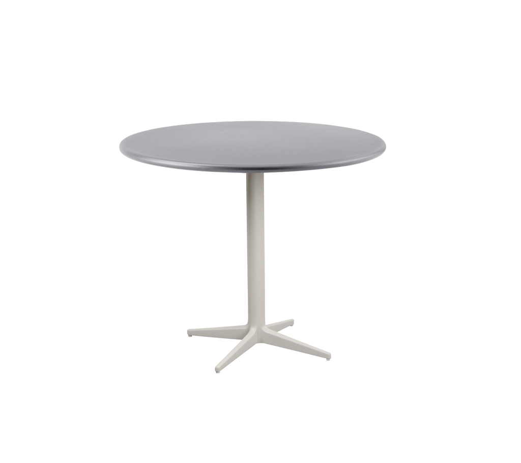 Table ronde moderne avec un plateau gris lisse et une base robuste de couleur claire avec un design à quatre pieds.