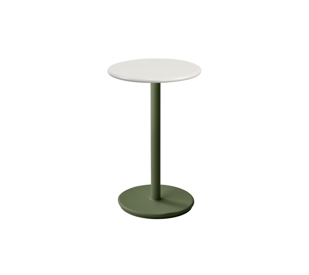 Table moderne vert foncé avec un dessus blanc dans un cadre de salon.
