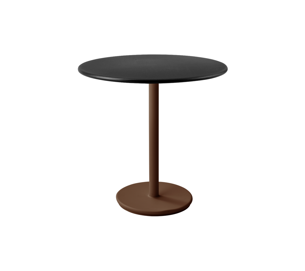 Table noire moderne avec une base rouge désert dans un cadre de salon.