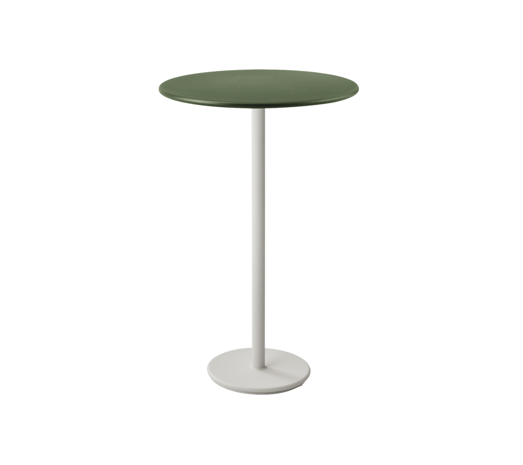 Table ronde vert foncé avec un pied blanc.