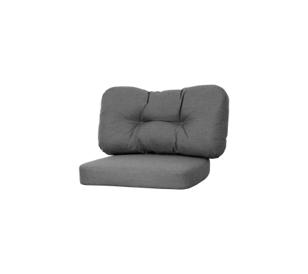 Fauteuil lounge rembourré gris avec un dossier et un siège en peluche, présentant des détails en relief pour un confort et un style supplémentaires.