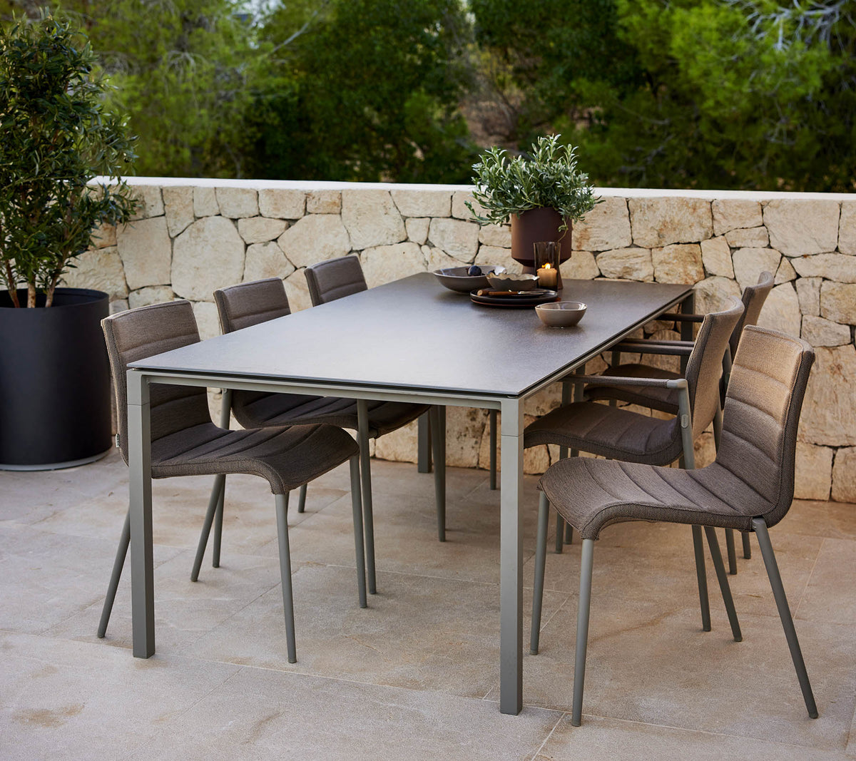 Une table pure et élégante avec un centre de table décoratif, entourée de chaises Core modernes pour un confort optimal.