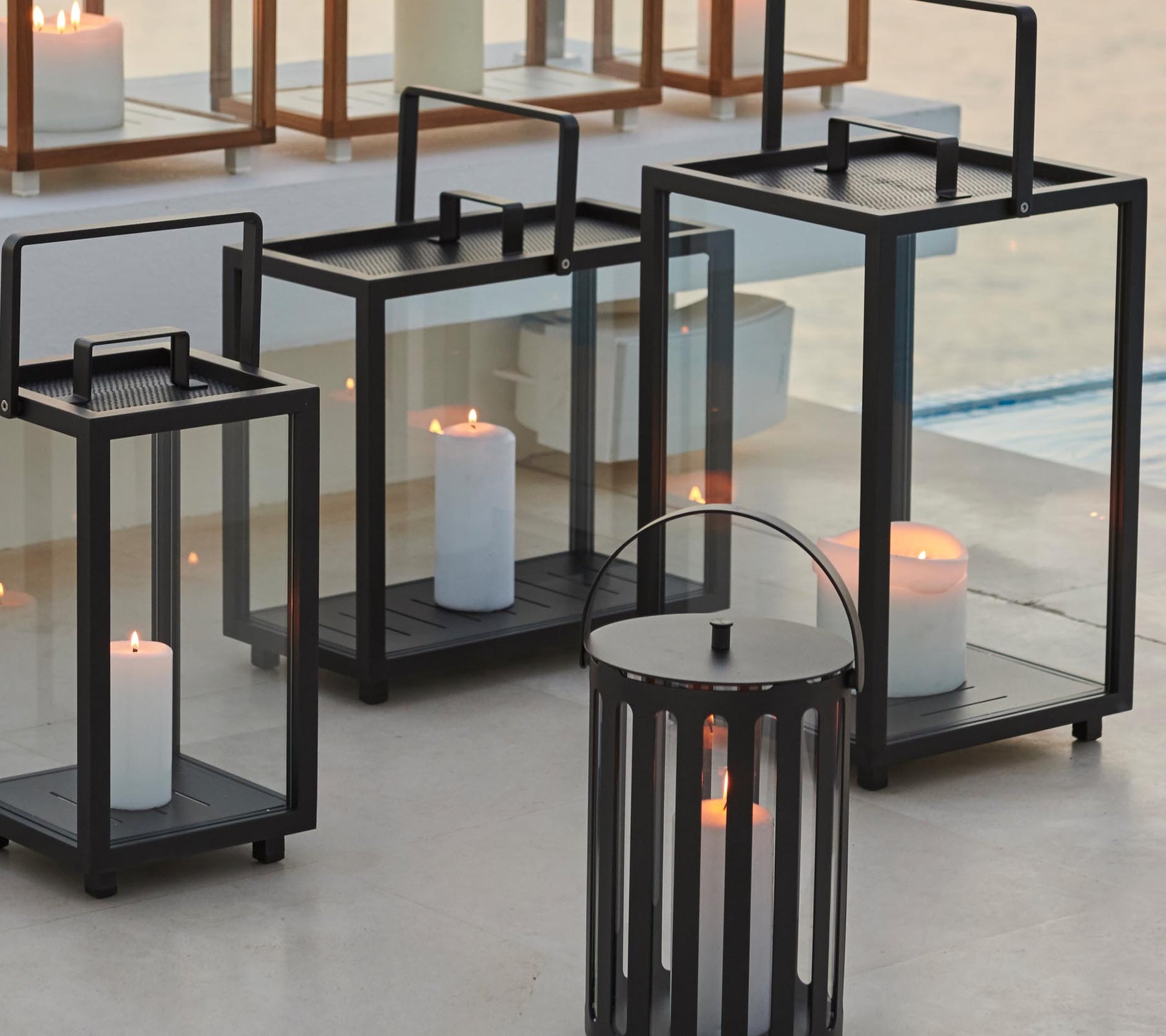 Des lanternes décoratives de différentes tailles avec des bougies à l'intérieur, créant une ambiance accueillante.