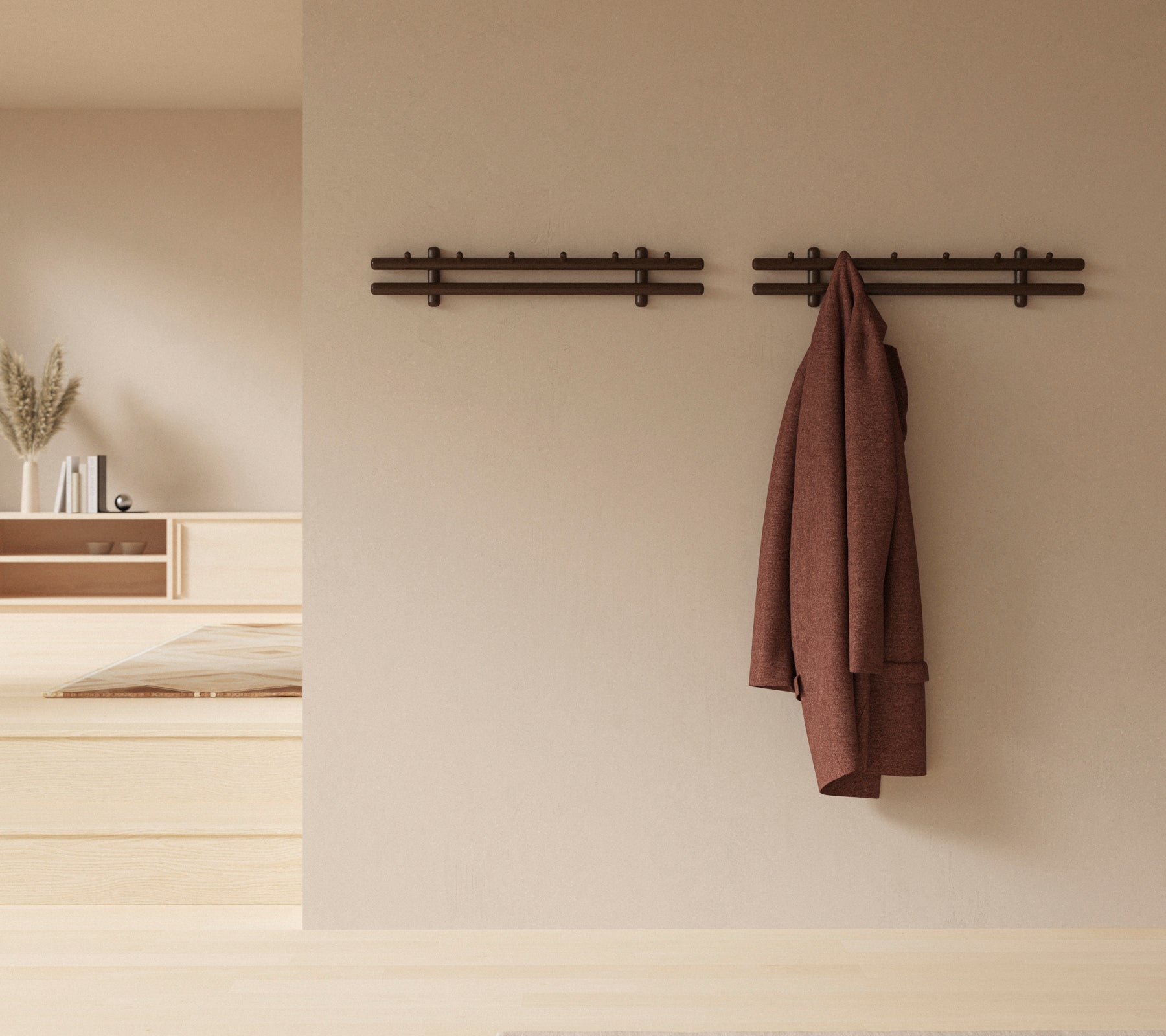 Un affichage mural minimaliste avec des bâtons en bois tenant un manteau et un ensemble de chiffons, améliorant l'esthétique du décor rustique.