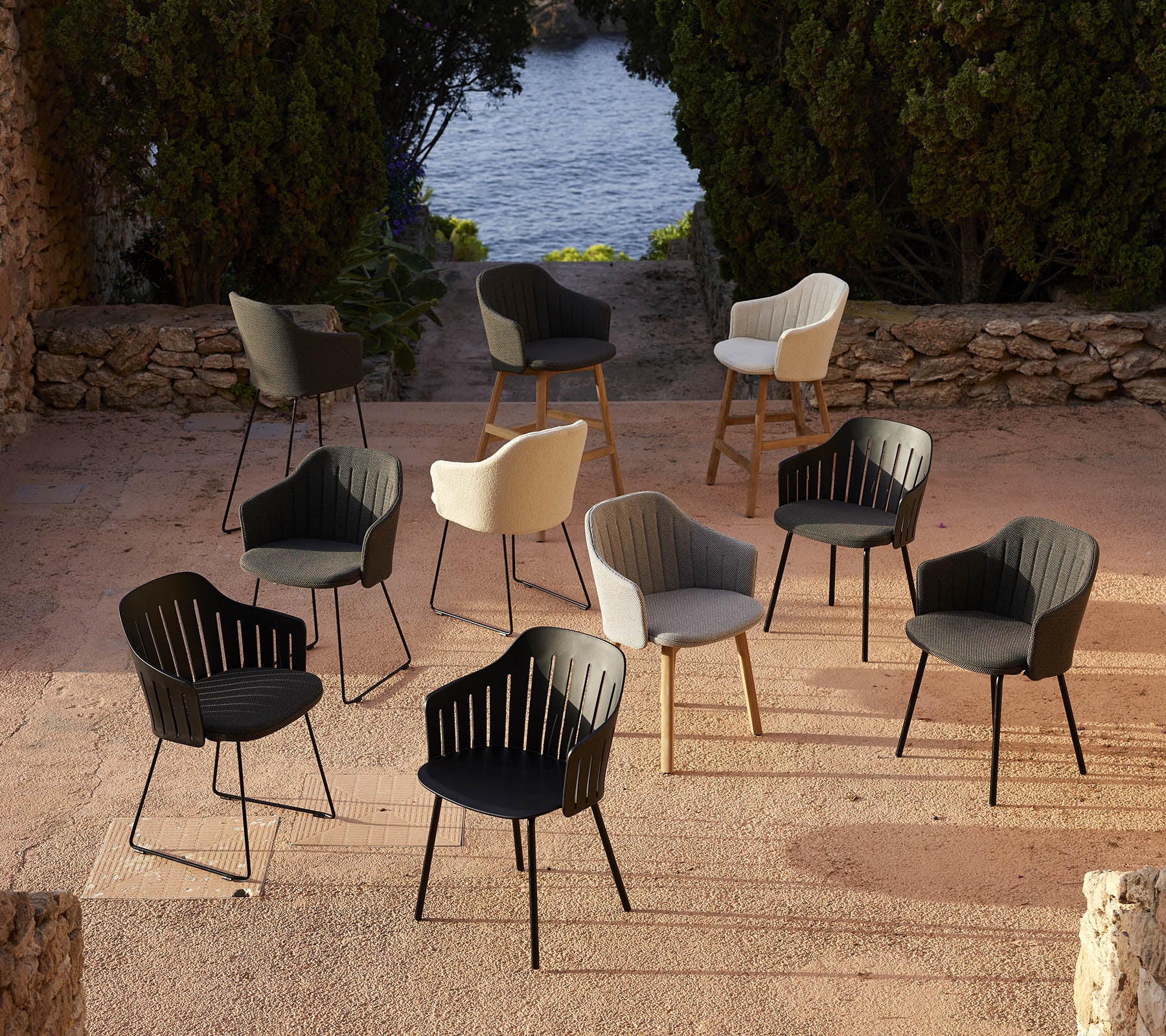 Une collection de chaises élégantes de différentes couleurs disposées dans un cadre pittoresque, mettant en valeur des choix de design polyvalents.